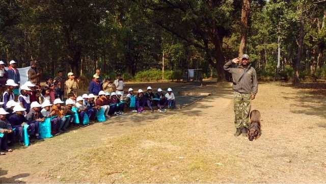 Children enjoy watching dog show and tiger at Kanha Tiger Reserve